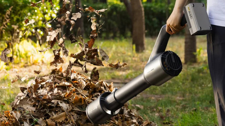 HOTO 20V Cordless Leaf Blower 720CFM blowing a pile of leaves
