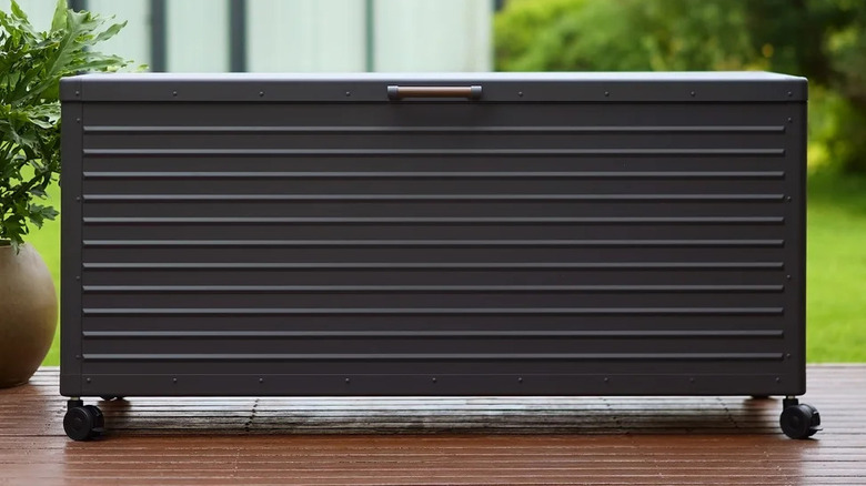 Mirador 205 Gallon Powder Coated Durable Metal Storage Box With Lockable Wheeled Base on a deck