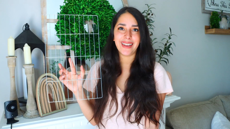 DIY creator holding a cooling rack.