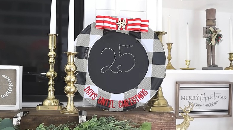 Black plaid charger plate with a chalkboard center to create a Christmas countdown