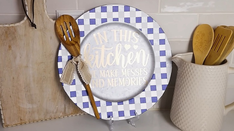 Charger plate with a wooden spoon attached sitting in a kitchen