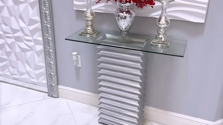 Accent table made from several rectangular charges stacked on top of one another