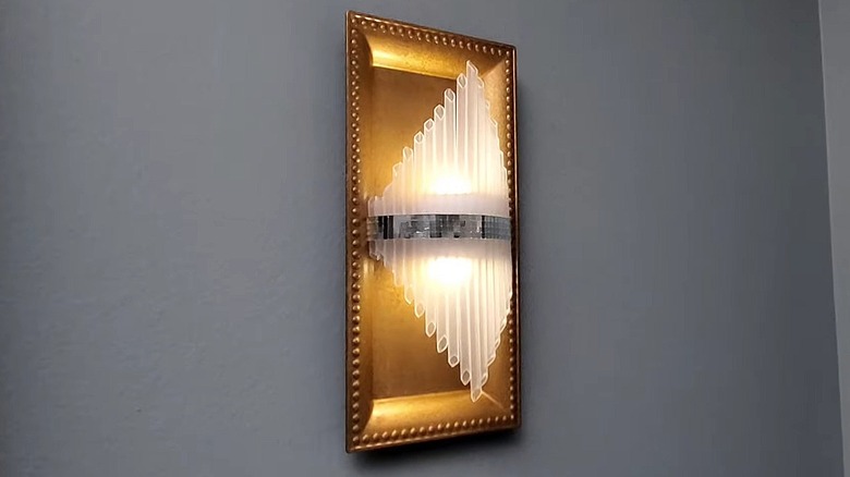 DIY wall sconce with a rectangle charger as the back plate
