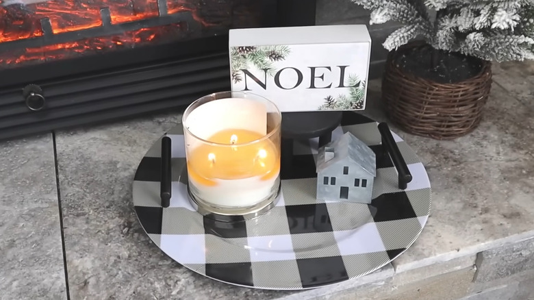 DIY tray made of black and white charger plate with black handles and holiday decor on top