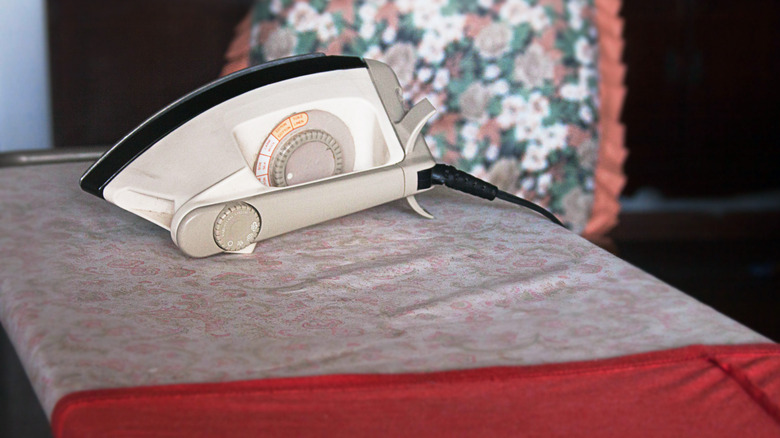 An old-school iron isolated on an ironing board