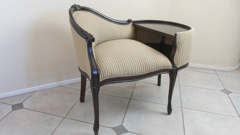 Restored vintage telephone bench on a tile floor