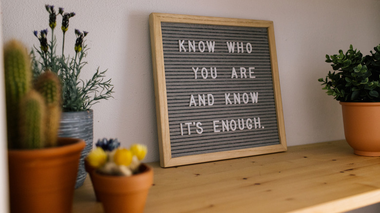 An inspirational quote on a letterboard on a shelf