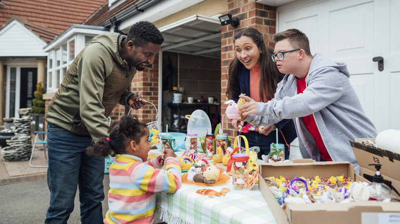 Buyers and sellers laughing and talking at garage sale