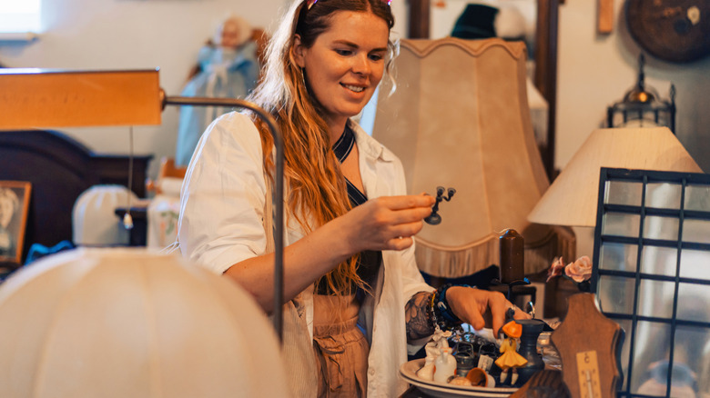 Woman looking at items in a thrift store