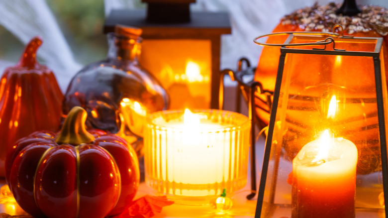 Assorted lanterns and candles with ceramic gourds