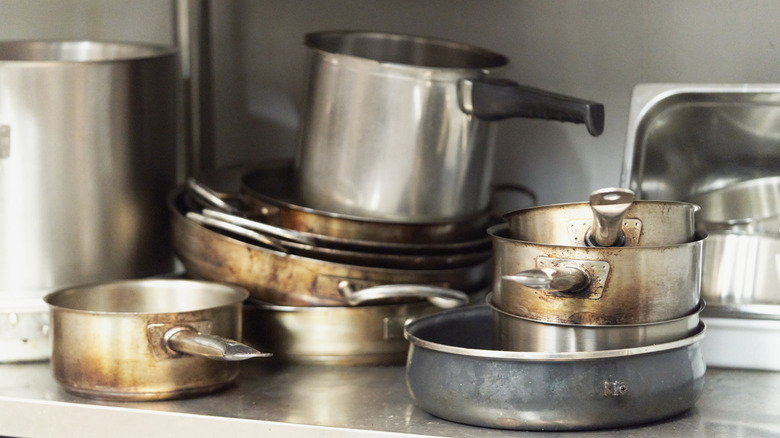 Stack of dirty pots and pans