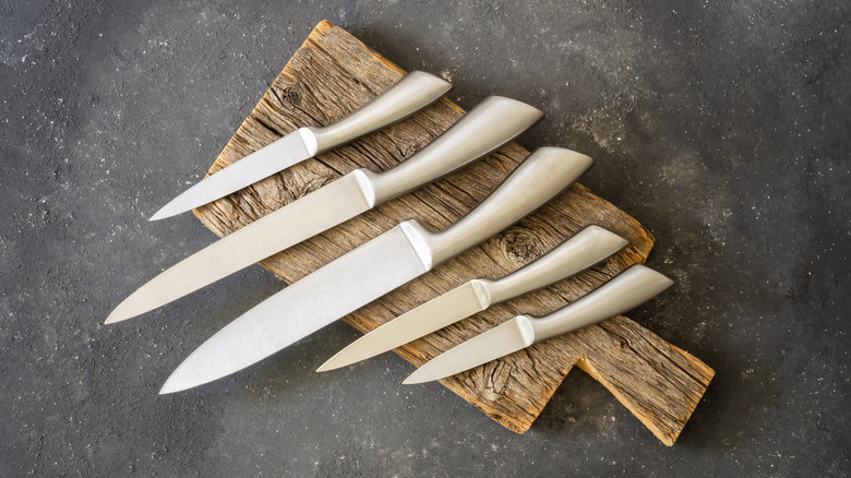 Kitchen knives on a wooden cutting board