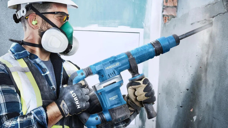 A man using Hercules 10 Amp, 12lb. SDS-MAX Type Demolition Hammer