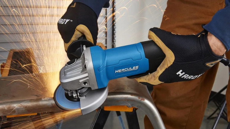 A person using an angle grinder made by Hercules