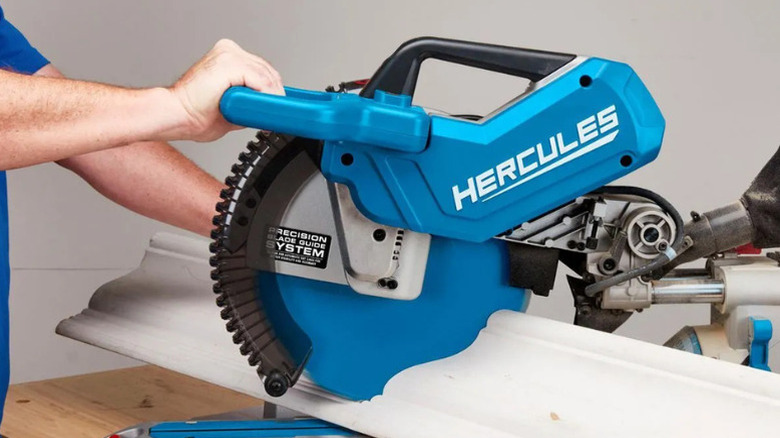 A person using Hercules' 12 in. Dual-Bevel Sliding Compound Miter Saw