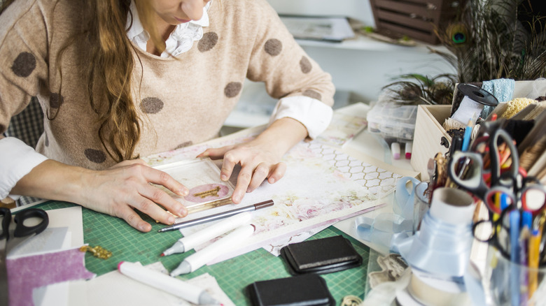 Woman using decorative paper to create a display
