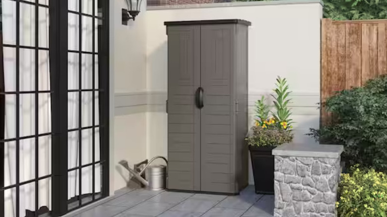 The Suncast grey shed on a patio.