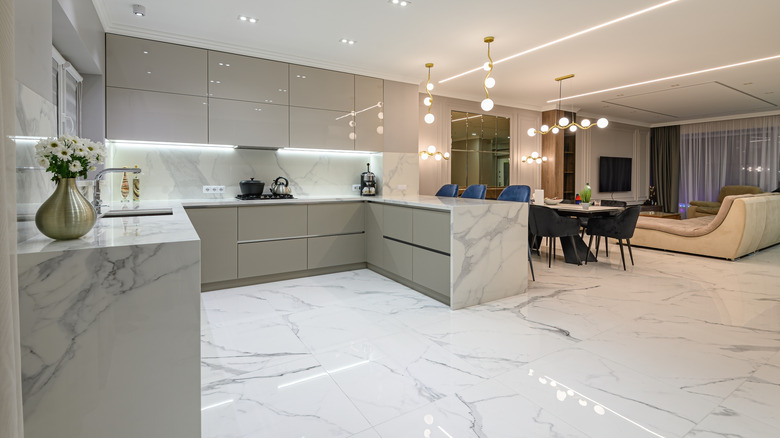 Glam kitchen with white and gray marble floor, counters, and backsplash