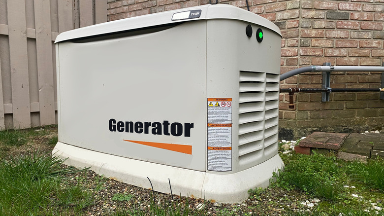A whole-home backup generator in backyard