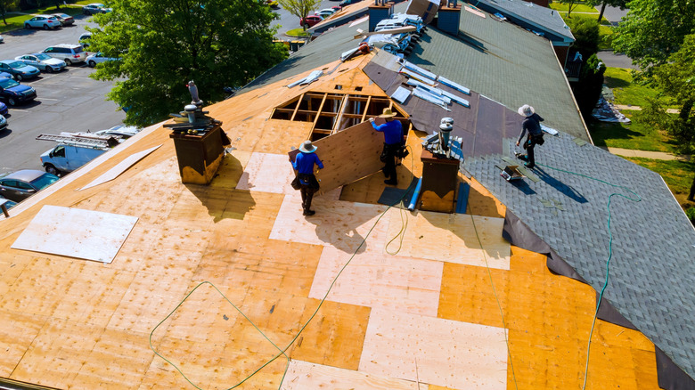 Asphalt shingles are being added to a new roof