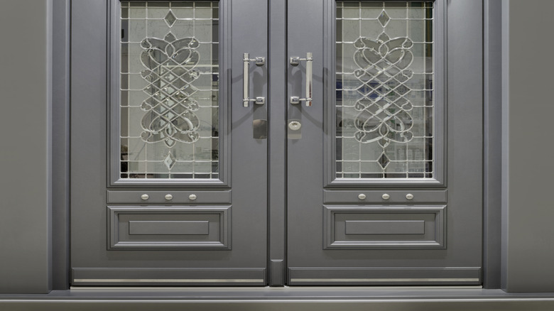 Large silver steel door with glass panels