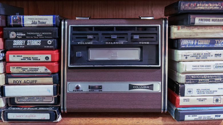 8-track player along with tapes of various artists