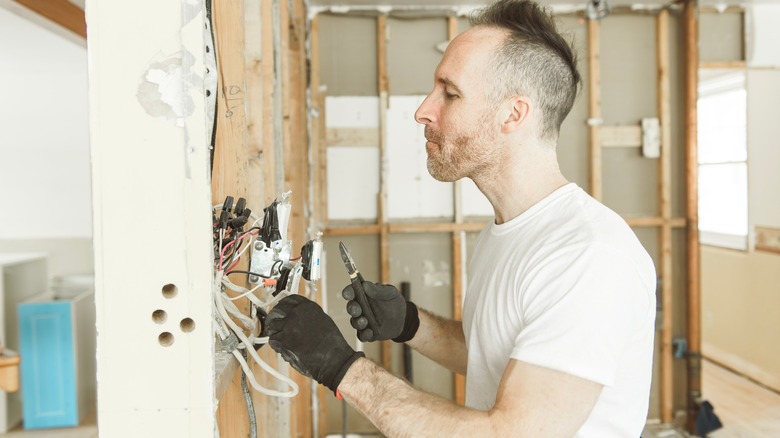 an electrician working on an old house