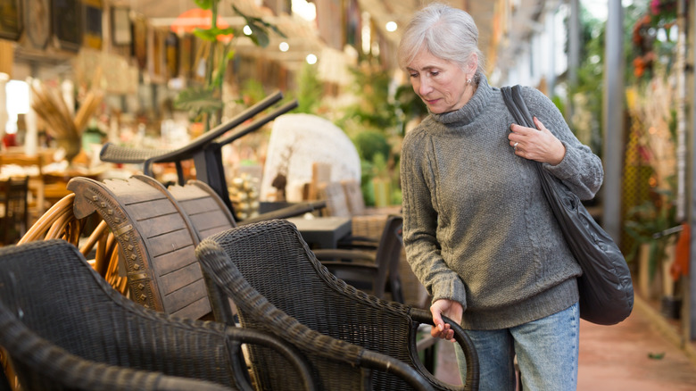 A person shopping for patio furniture in a store