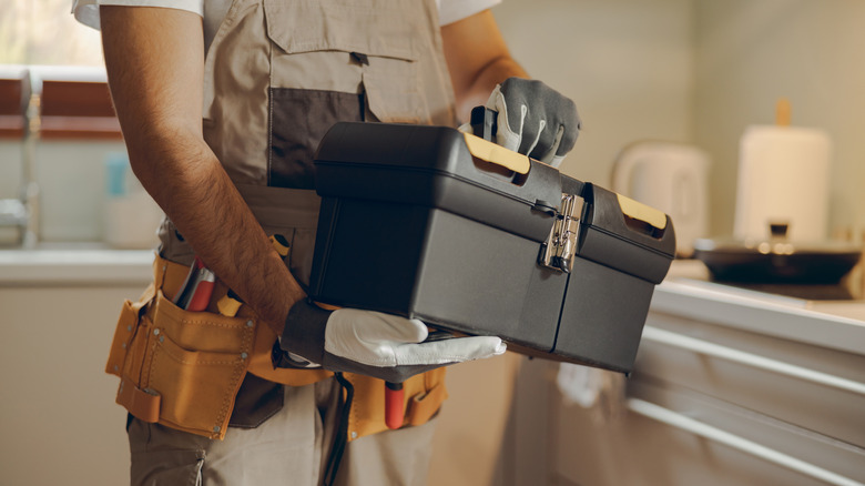 person holding toolbox