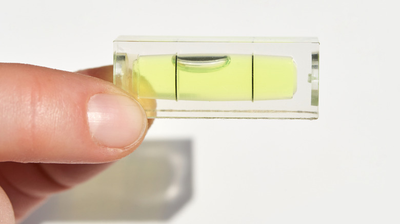 hand holding mini bubble level