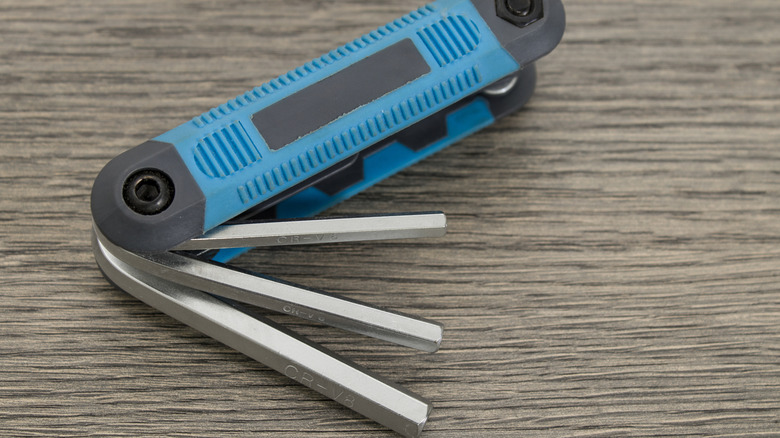 Blue multitool allen keys on a wood table
