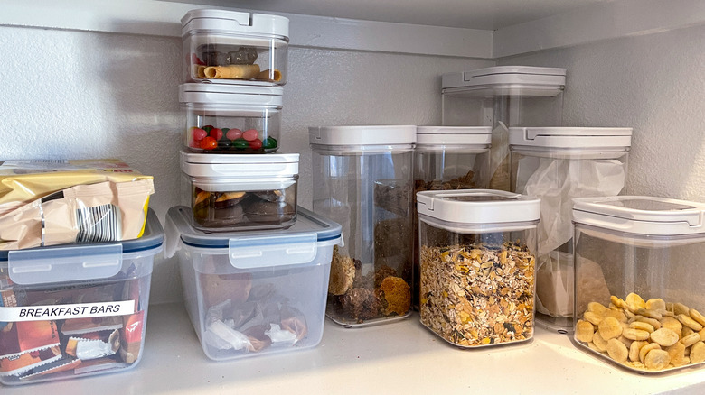 Pantry shelf with snacks and cereal in containers