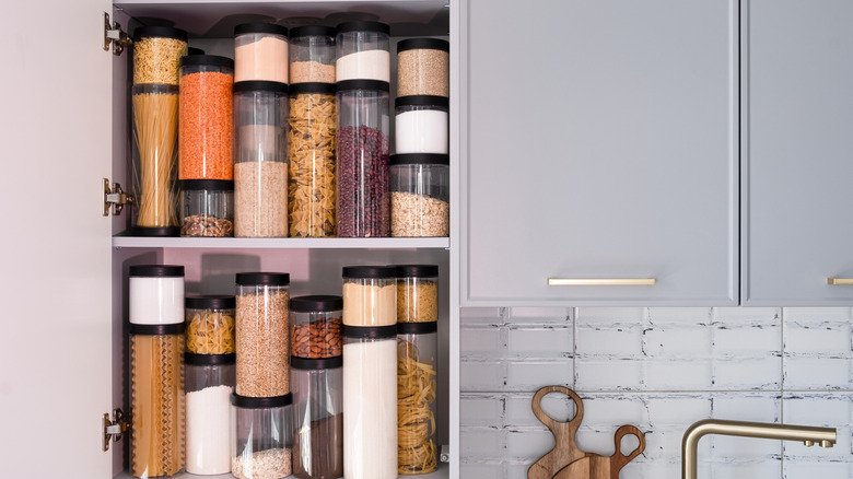A pantry organized with various jars.