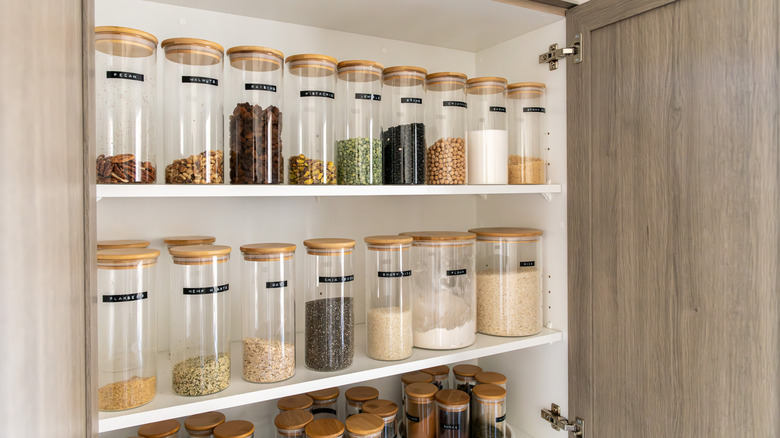 An interior look at a pantry with labeled jars.
