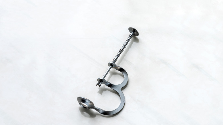 A spring-loaded vintage cherry pitter