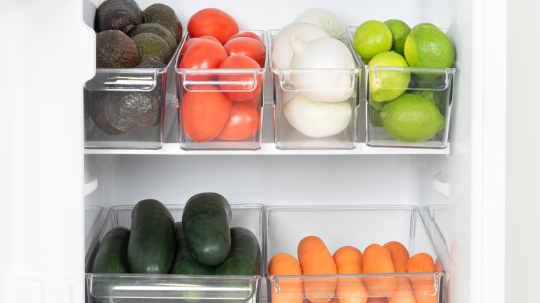 Fruits and vegetables organized by type into clear plastic bins