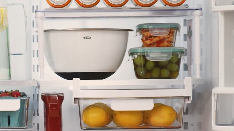 A refrigerator riser and an under-shelf drawer to increase space in the refrigerator