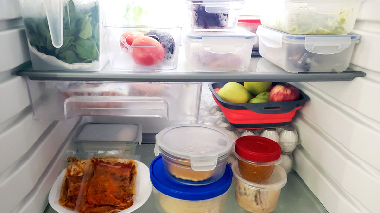 Disorganized fridge with food items stored randomly