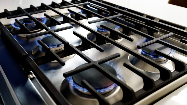 gas cooktop with six burners that have been lit