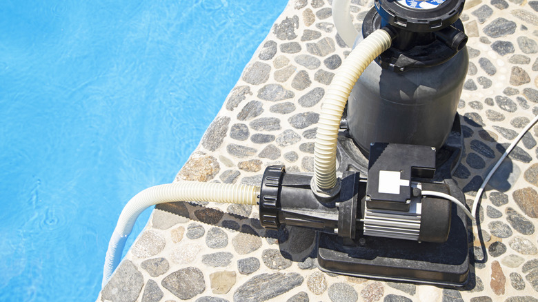 pool pump beside a pool