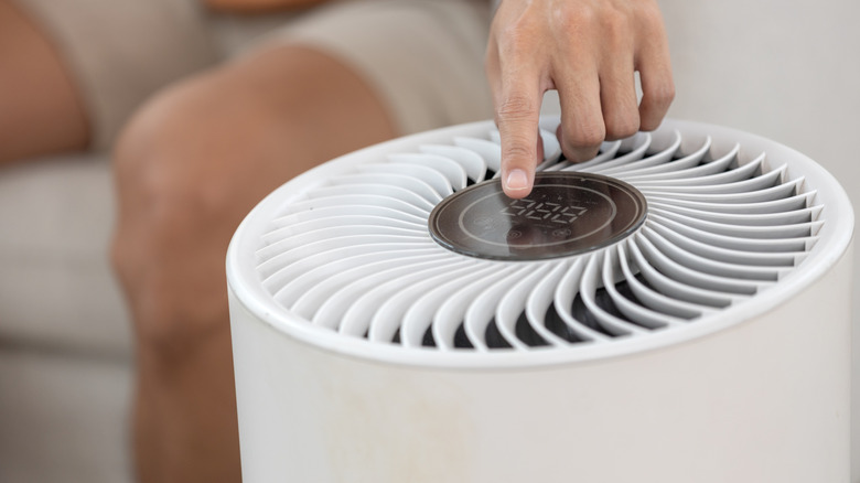 person turning on air purifier