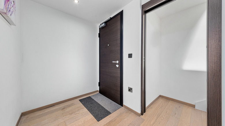 Empty entryway in a new home without storage or drop area