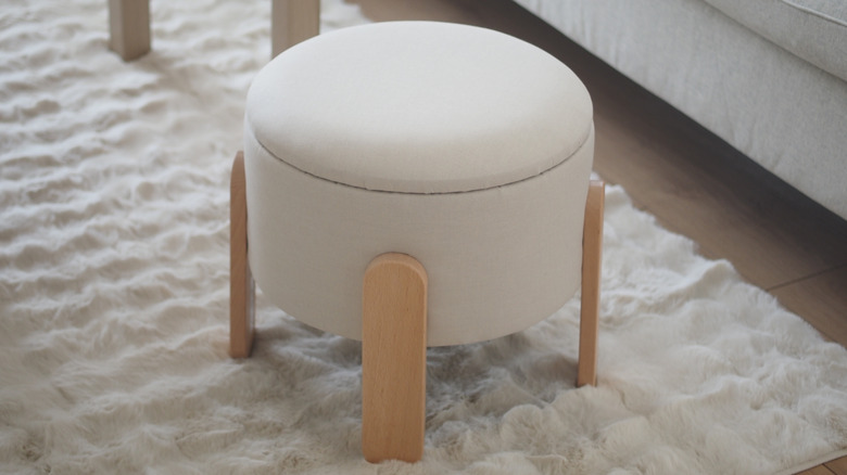 An ottoman stool with a removable lid for storage inside