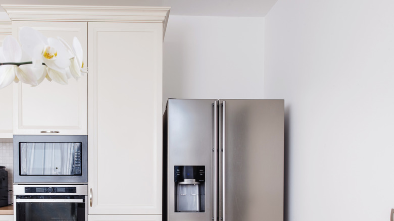 A shot of a kitchen showing a fridge with lots of unused space above it