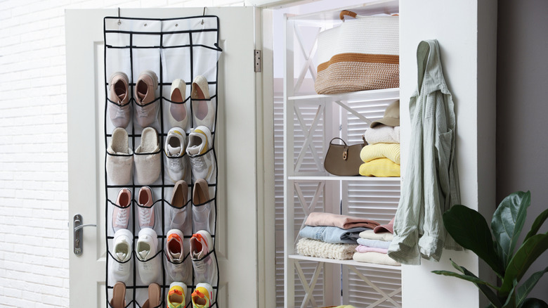 Over-door organizer holding shoes on back of a closet door