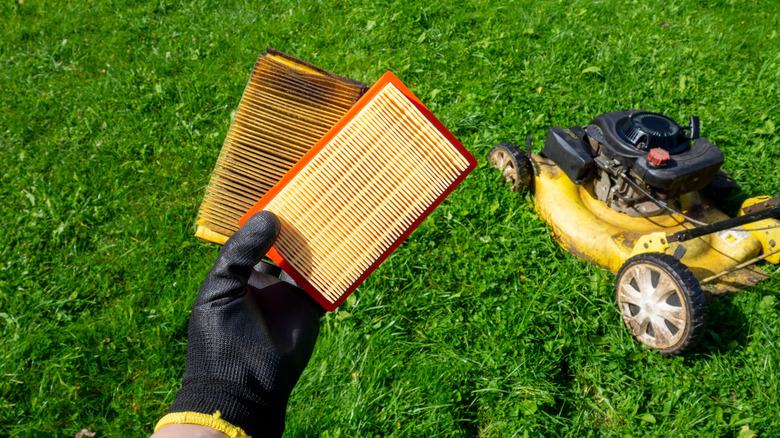 Person holding lawn mower air filters