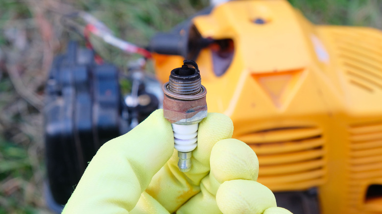 Person holding damaged spark plug
