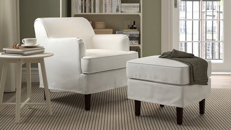A white IKEA ROCKSJÖN armchair on a striped rug