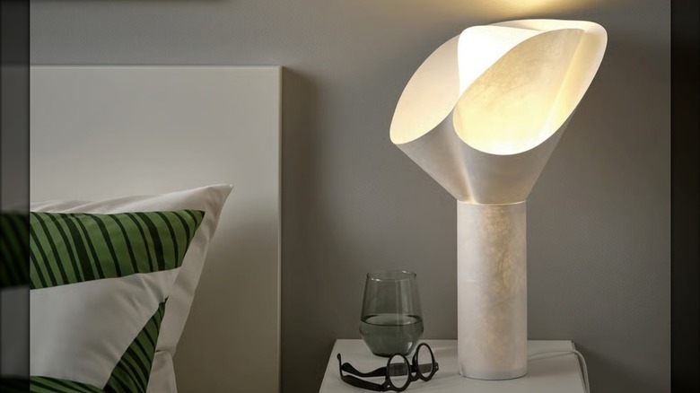 IKEA's BÄCKNATE table lamp on a nightstand next to a bed
