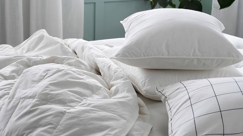 Three IKEA GULKAVLE pillows on an unmade bed